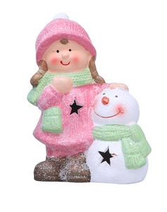 Close-up of magnesium oxide girl and snowman ornament with glitter and star-shaped cutouts