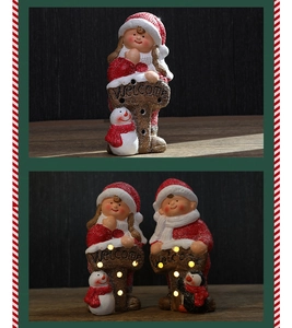 Close-up of glowing Christmas ceramic figurines with warm LED light and Welcome sign