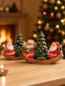 Detail view of a festive ceramic Christmas boat light featuring Santa and a snowman