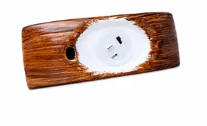 Detail of Christmas ornament base featuring a wood-grain finish and a power switch
