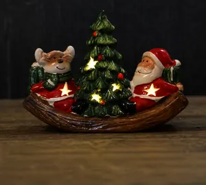 Christmas ceramic glowing decor with Santa, tree, and warm LED light on wooden base