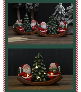 Close-up of glowing LED Christmas tree with resin Santa Claus on a wooden rocker base