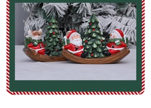 Detail of hand-painted ceramic Christmas rocking boat ornaments with Santa and Snowman