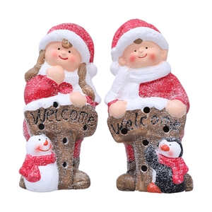 Christmas ceramic figurines set with Welcome sign featuring a boy and girl in red holiday outfits