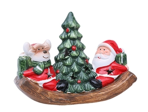 Close-up of Christmas rocking ornament with Santa and bear on a faux wood base