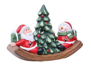 Detail of Christmas ceramic candle holder with Santa and snowman on rocking base