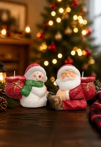 Detail of Christmas Santa and snowman ceramic paraffin candles with textured snow finish
