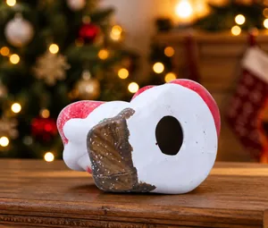 Detail view of the Christmas candle holder base made of painted resin with colorful festive trim