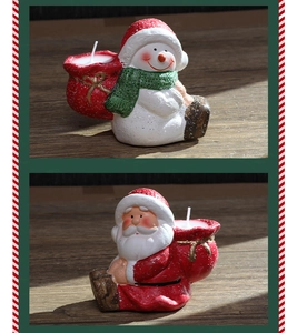 Close-up of Santa and snowman paraffin candles with sparkling glitter texture detail