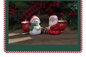 Close-up of Santa and snowman ceramic paraffin candle holders with sparkling glitter finish