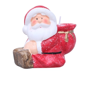 Macro detail of hand-painted Santa Claus ceramic candle with gift bag and white wick