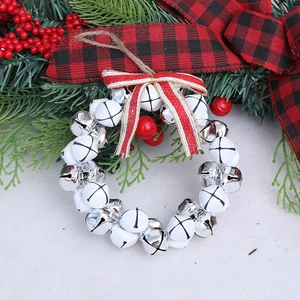 Exquisite Christmas wreath with silver and white bells, red bow, and festive pine branches