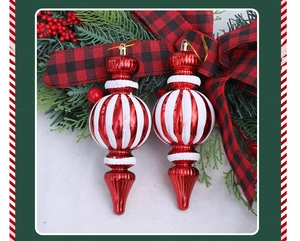 Detalle de adornos navideños de gota con rayas en espiral rojas y blancas con ganchos