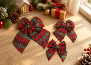 Detailed view of three sizes of red and green plaid bows for Christmas tree decoration