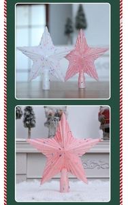 Nahaufnahme von glitzernden Sternen in Rosa und Weiß für die Weihnachtsbaumspitze