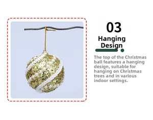 Detail of a gold glitter Christmas ball with white pearls hanging on a tree branch