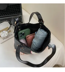 Spacious interior of retro polka dot tote bag showing phone, wallet, and umbrella