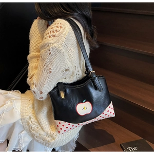 Detail of cute apple print shoulder tote bag with red polka dot patchwork design