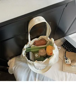 Interior view of large white canvas tote bag showing spacious compartments with everyday essentials