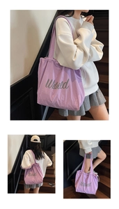 Detail of purple canvas tote bag featuring drawstring closure and Wild letter print