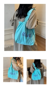 Detail of light blue tote bag with purple Udbild print and wide shoulder strap