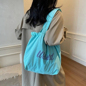 Minimalist bright blue tote bag with purple Unbuild print for casual commuting