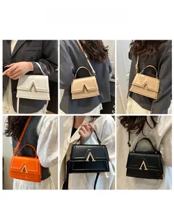 Detailed views of crossbody bag in four colors showing V-shaped metal clasp and strap