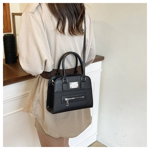 Detail showing the black PU leather biker tote with silver hardware and shoulder strap