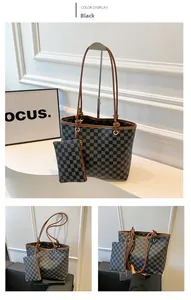 Detail of checkered bucket bag and wallet set with brown straps and golden hardware