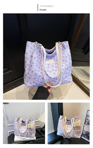 Detail of purple tote bag featuring 3D pleated fabric and all-over bow pattern