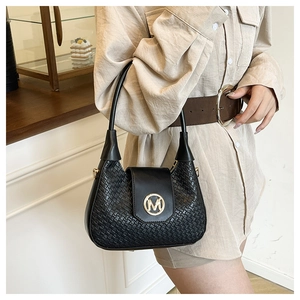 Detail of black woven crescent bag with golden M logo and metallic hardware