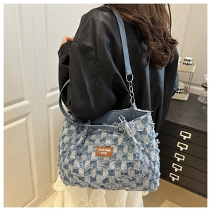 Blue and white checkered tote bag with frayed edges and silver chain strap detail