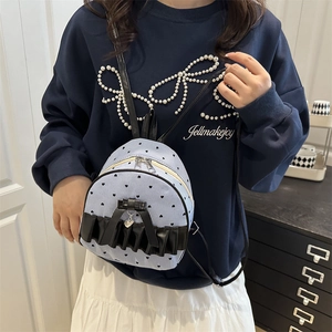 Blue striped mini backpack with black heart prints and decorative ruffles and ribbons