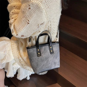 Vintage gray bucket bag with matte texture, gold rivets and top handles for women