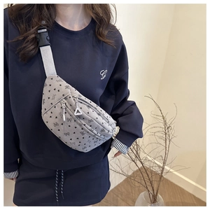 Detail of light gray corduroy crossbody bag with heart prints and adjustable strap