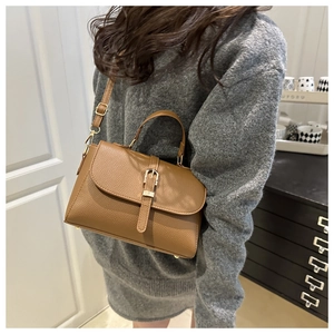 Brown litchi grain leather shoulder bag featuring a vintage buckle and chain strap