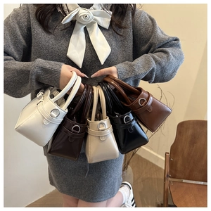 Detail shot of mini tote bags in various colors with polished metal ring hardware