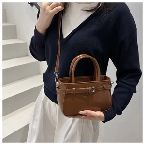 Brown vintage square handbag with decorative buckle and adjustable shoulder strap for women