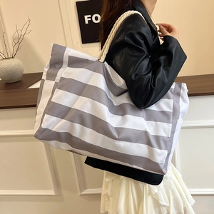 Large striped canvas tote bag for women featuring white rope handles and gray pattern