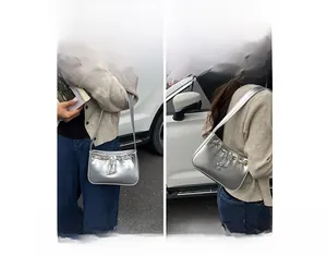 Silver faux leather handbag showing versatile ways to wear it as a shoulder or tote bag