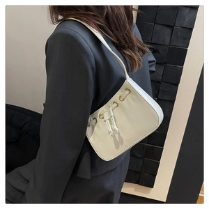 Detailed side view of an off-white shoulder bag with drawstring and eyelet accents