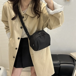 Minimalist black nylon crossbody bag for women with adjustable strap for casual daily use