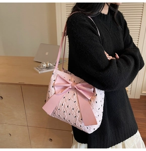 Close-up of pink quilted tote bag with black bunny print and large decorative bow