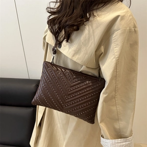 Minimalist large brown leather envelope bag with silver stud V-pattern on front