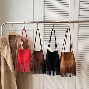 Retro fringe bucket bags in red, brown, black and tan colors with long tassel detail