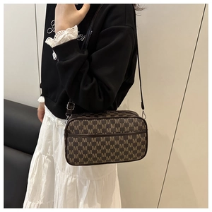 Détail du sac bandoulière marron café avec motif M vintage et bandoulière ajustable