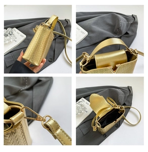 Macro detail of gold woven texture bag with metallic V buckle and dual strap options