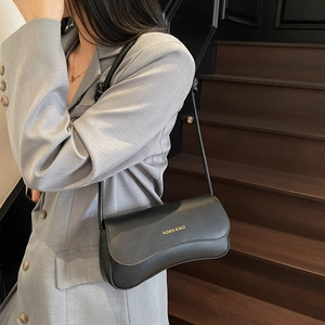 Classic black leather baguette shoulder bag for women with gold fashion logo lettering