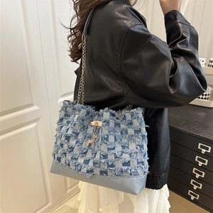 Blue checkerboard denim tote bag with chain strap and gold giraffe charm decoration