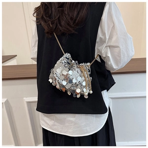 Detail of silver paillette bucket bag with gold chain and pearl drawstring charms